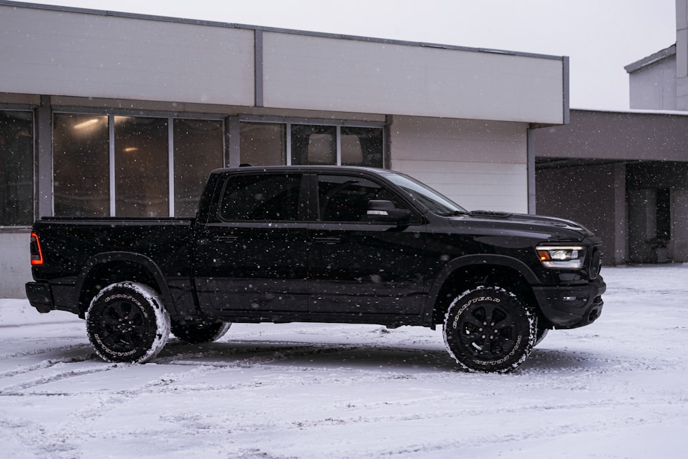 a black truck parked in front of a building