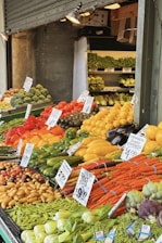 a large display of fruits and vegetables at a market