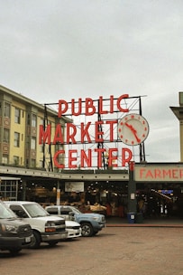 a public market center with cars parked in front of it