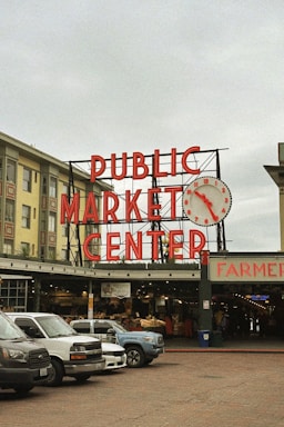 a public market center with cars parked in front of it