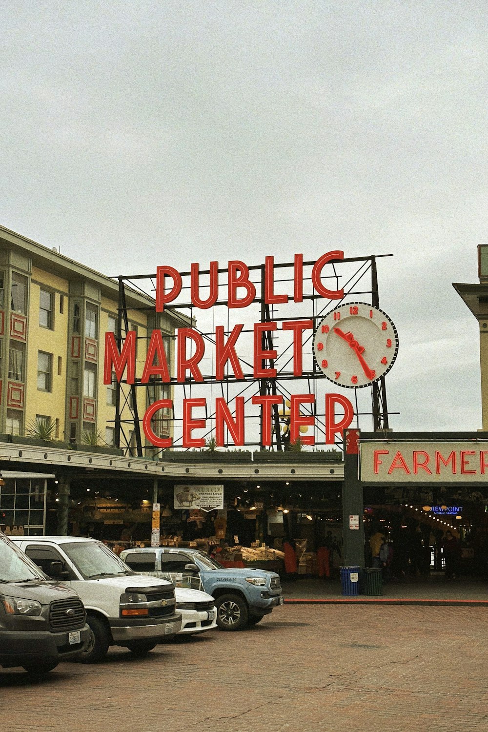 a public market center with cars parked in front of it
