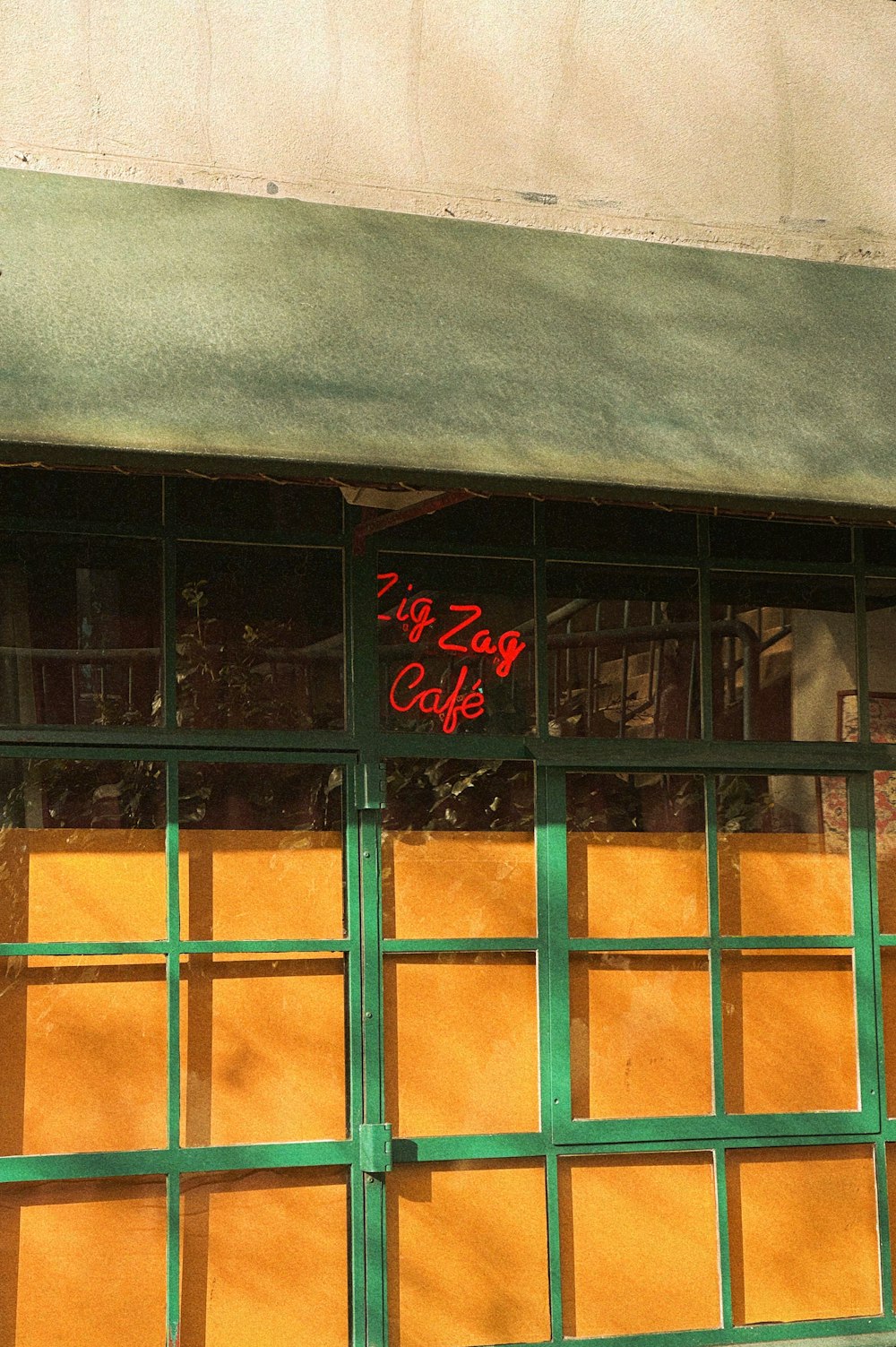 a store front with a clock on the side of it