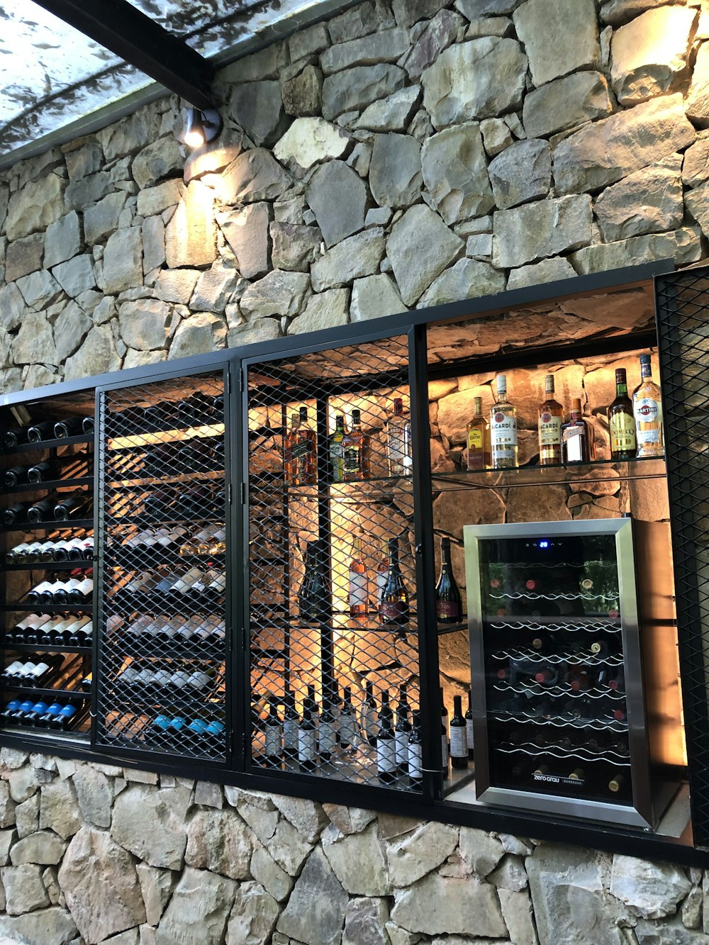 a wine cellar with a stone wall behind it