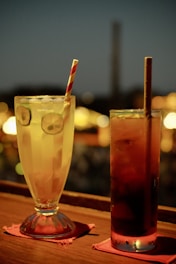 a couple of drinks sitting on top of a wooden table