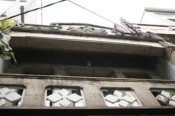 Urban architectural facade featuring natural stone cladding in a cityscape setting.