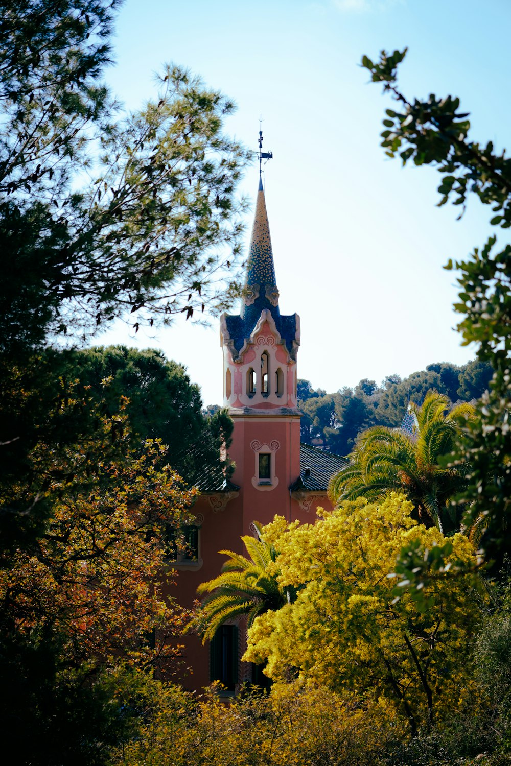 a church with a steeple surrounded by trees