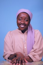 A friendly customer service representative wearing a headset, smiling warmly.