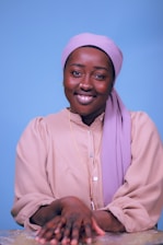 A friendly customer service representative wearing a headset, smiling warmly.