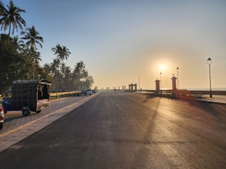 A peaceful early morning scene along the palm-lined streets of Goa, inviting travelers to unwind.