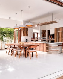 a kitchen with a table, chairs and a refrigerator