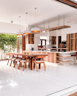 a kitchen with a table, chairs and a refrigerator