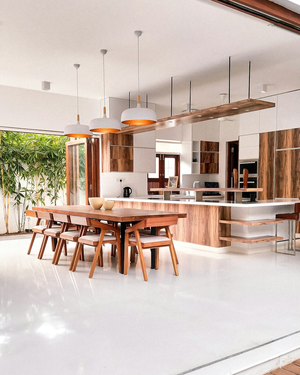 a kitchen with a table, chairs and a refrigerator