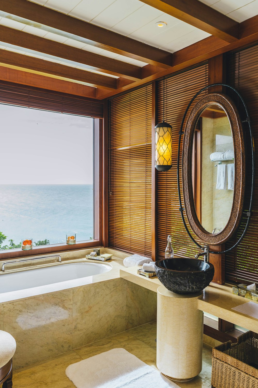a bathroom with a tub and a large window