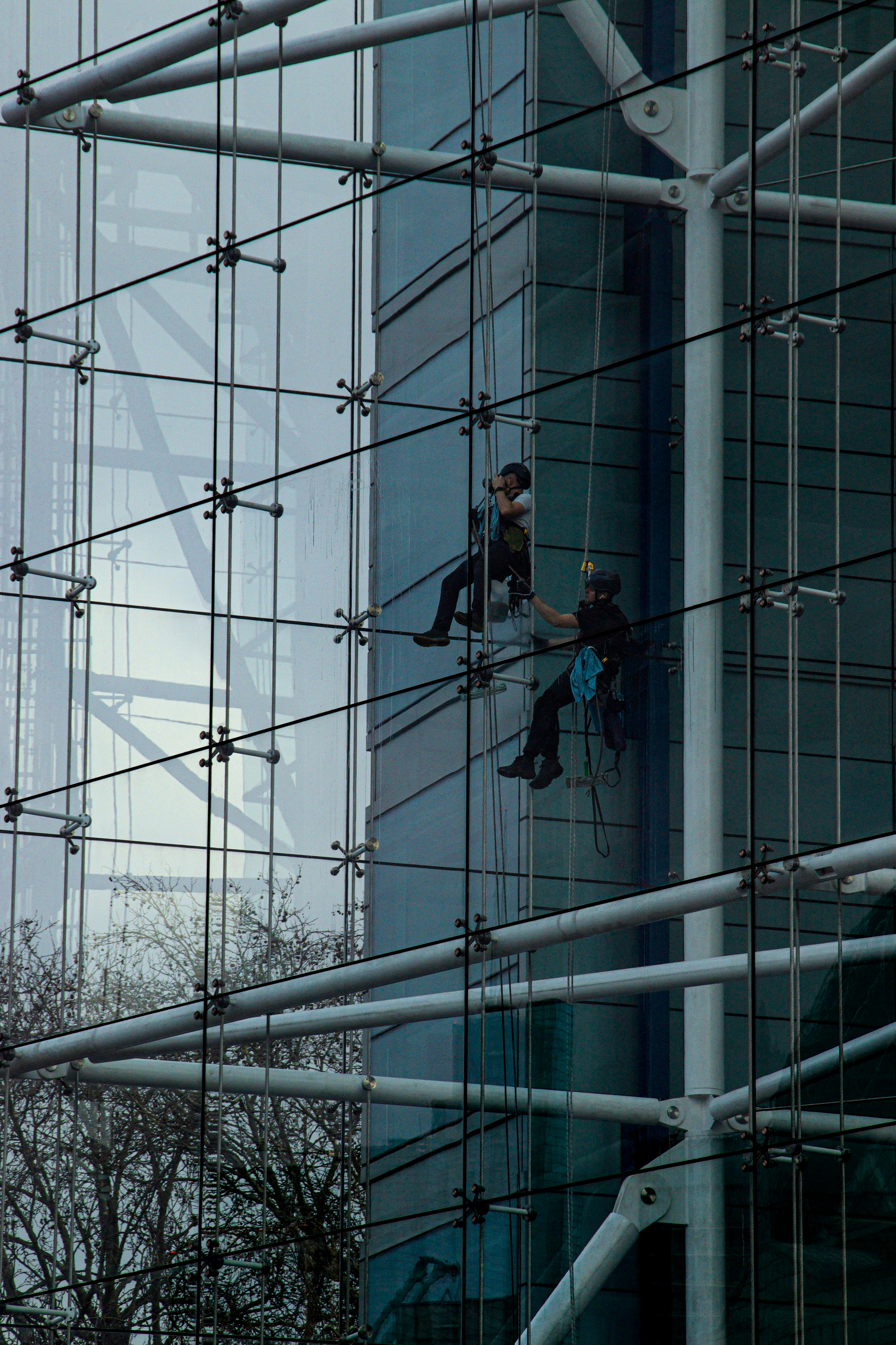 a man climbing up the side of a tall building