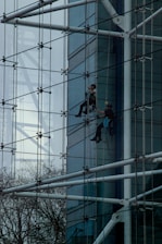 a man climbing up the side of a tall building