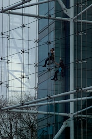 a man climbing up the side of a tall building
