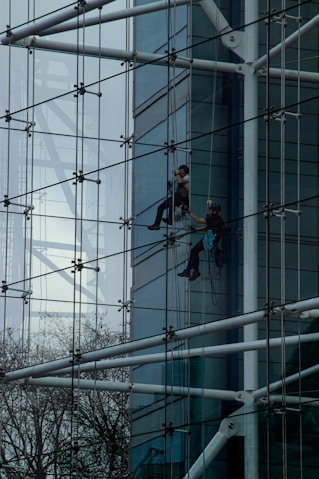 a man climbing up the side of a tall building