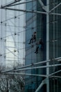 a man climbing up the side of a tall building