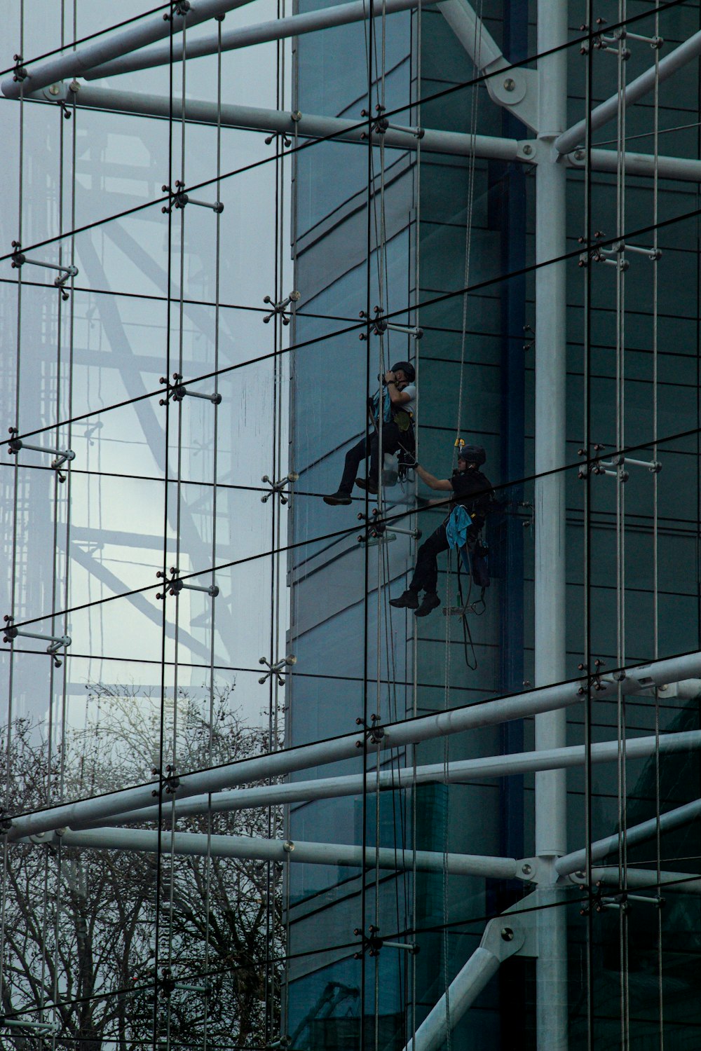 a man climbing up the side of a tall building