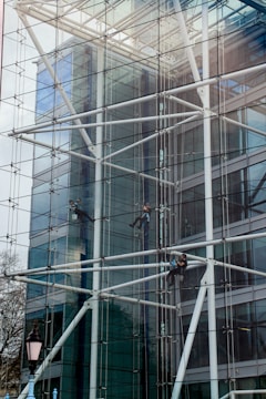 a man on a scaffolding system working on a building