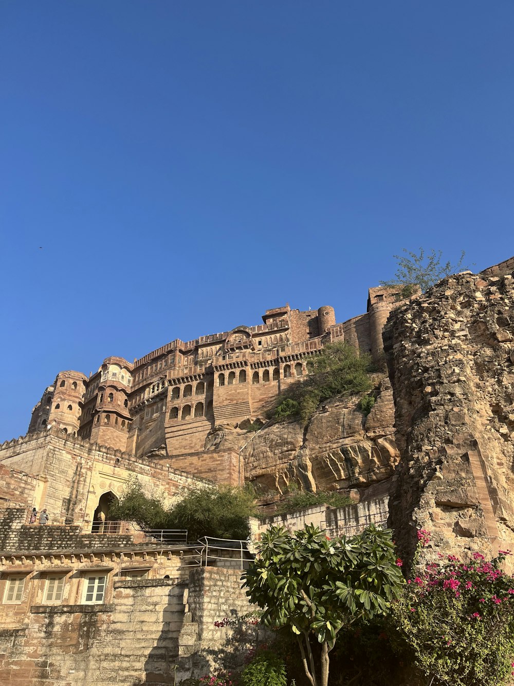 a castle on top of a hill with a blue sky in the background