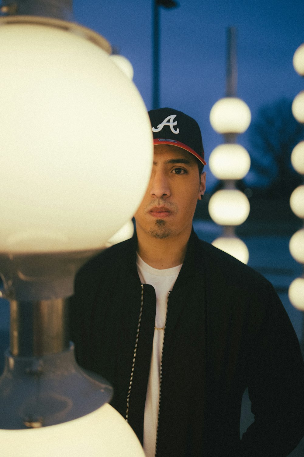 a man standing in front of a lamp