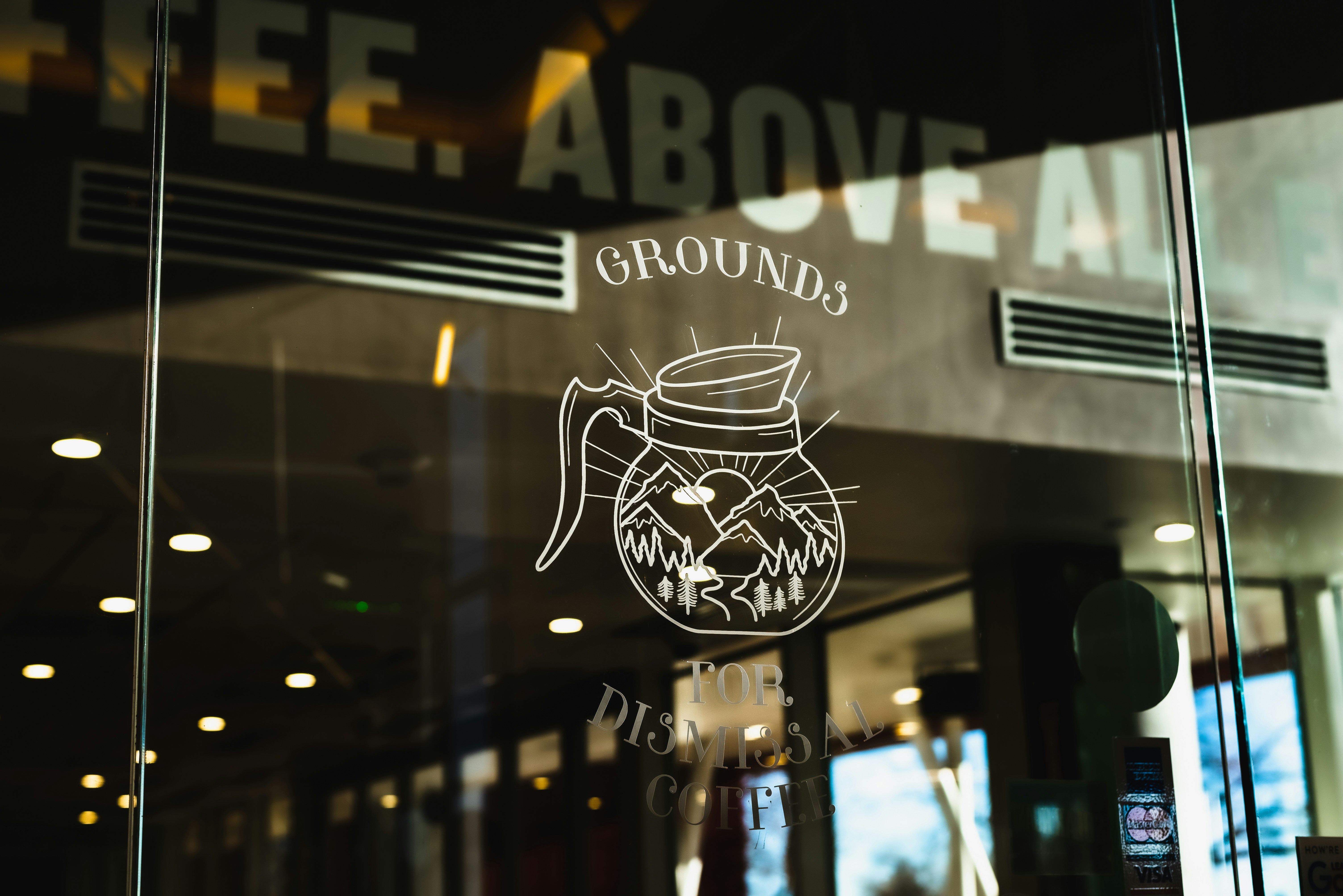 a glass window with a drawing of a coffee mug