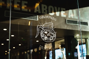 a glass window with a drawing of a coffee mug