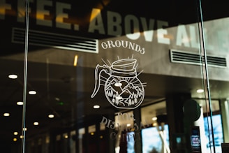 a glass window with a drawing of a coffee mug