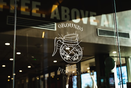 a glass window with a drawing of a coffee mug