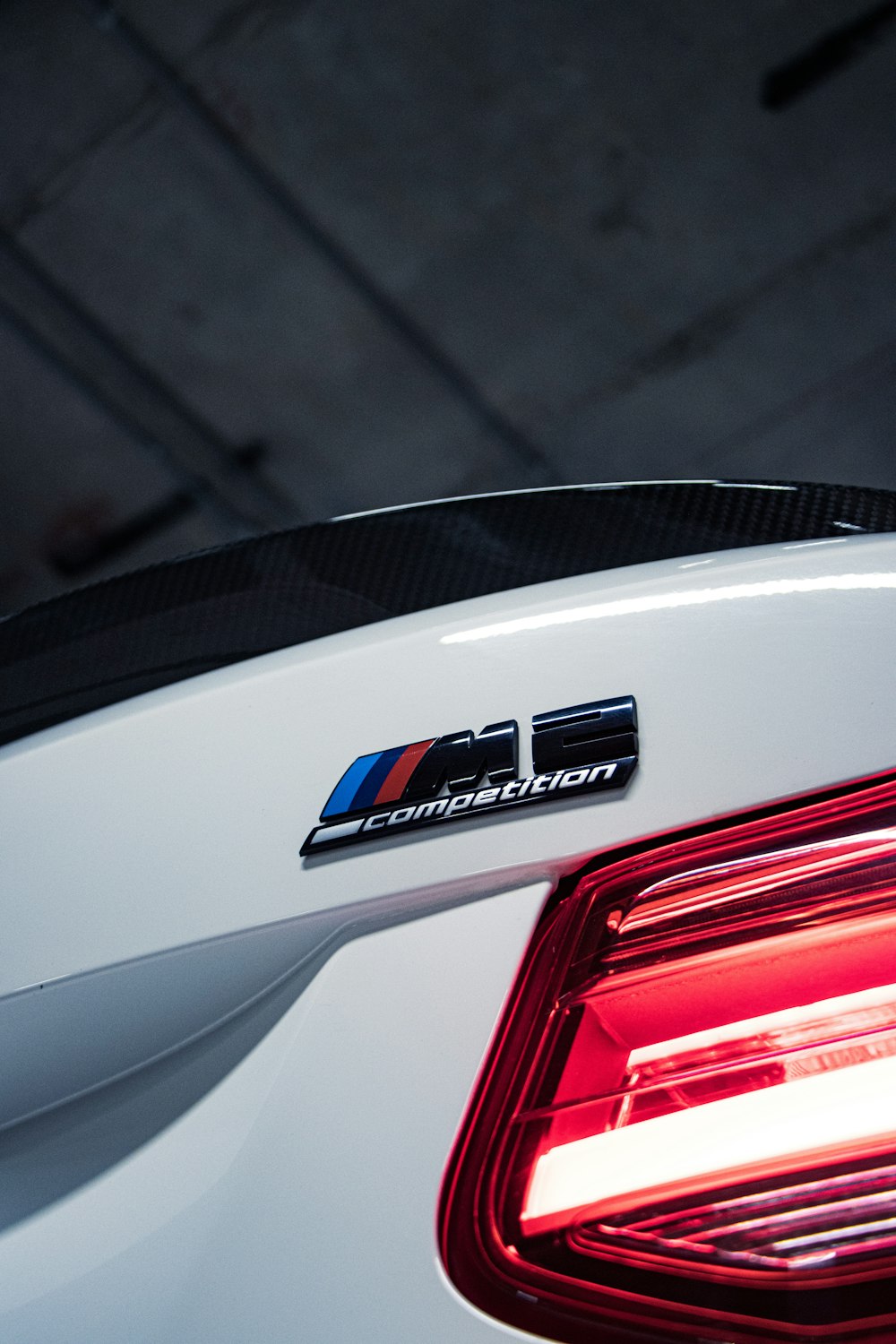 the tail light of a white bmw car