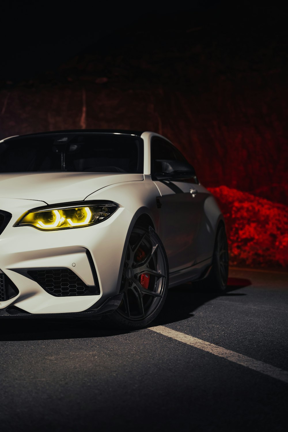 a white sports car parked on the side of the road