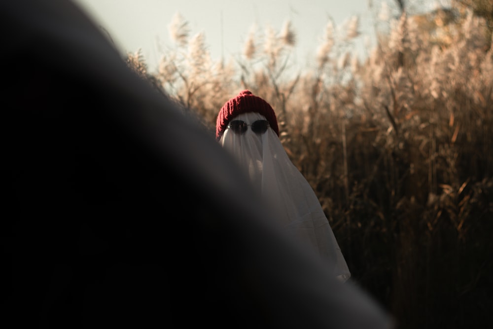 a person wearing a red hat and sunglasses