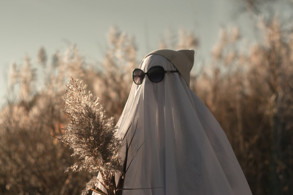 a person wearing a white veil and sunglasses