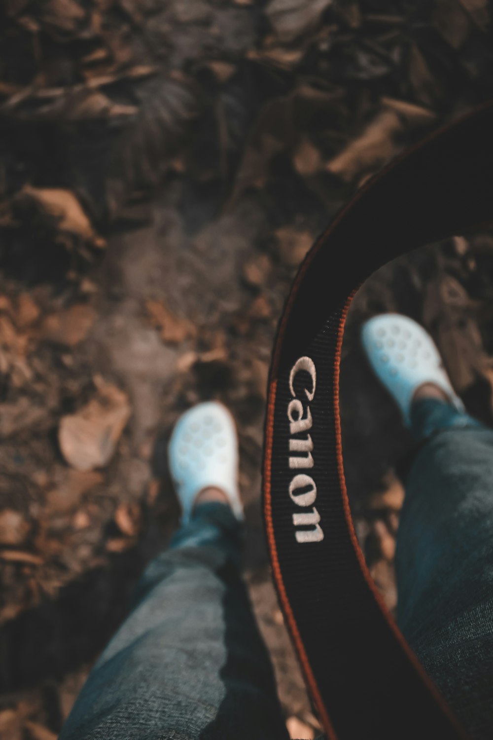 a person standing in the woods with their feet on the ground