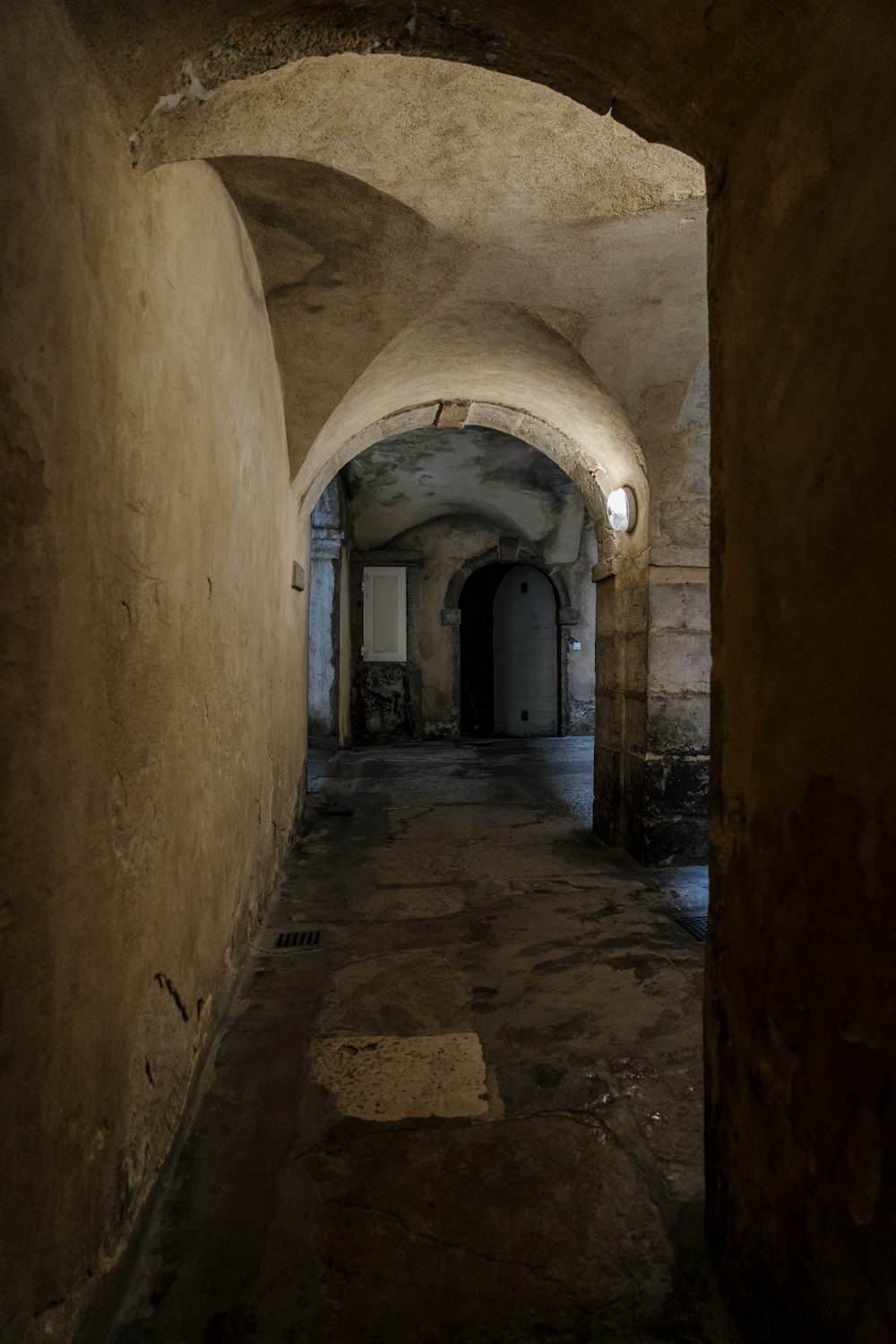 a long narrow hallway with a light at the end