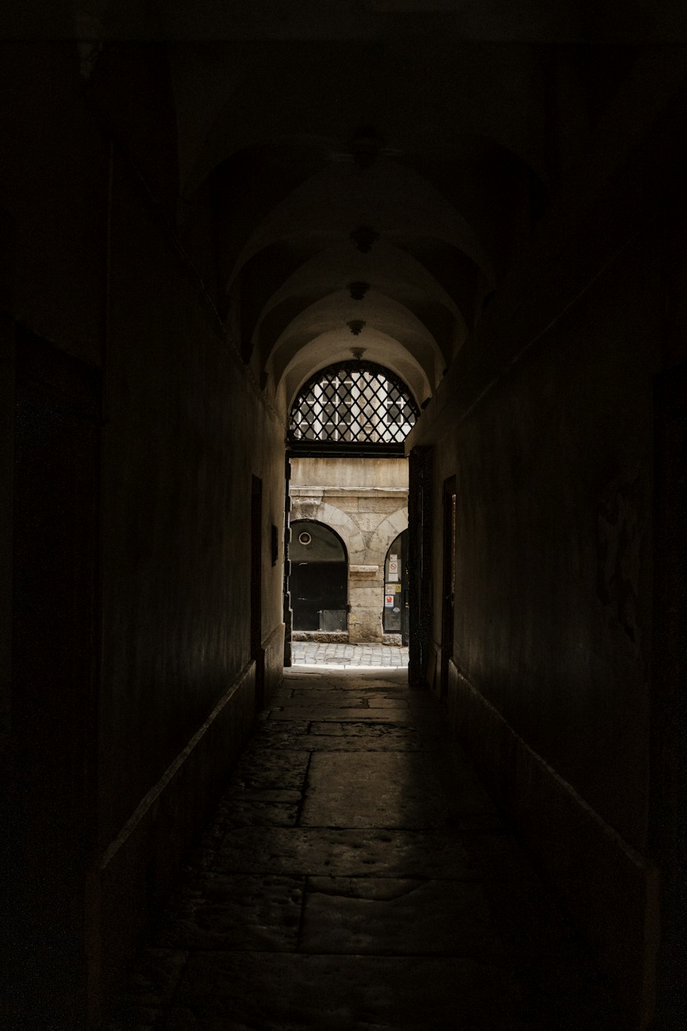 a dark hallway with a light at the end