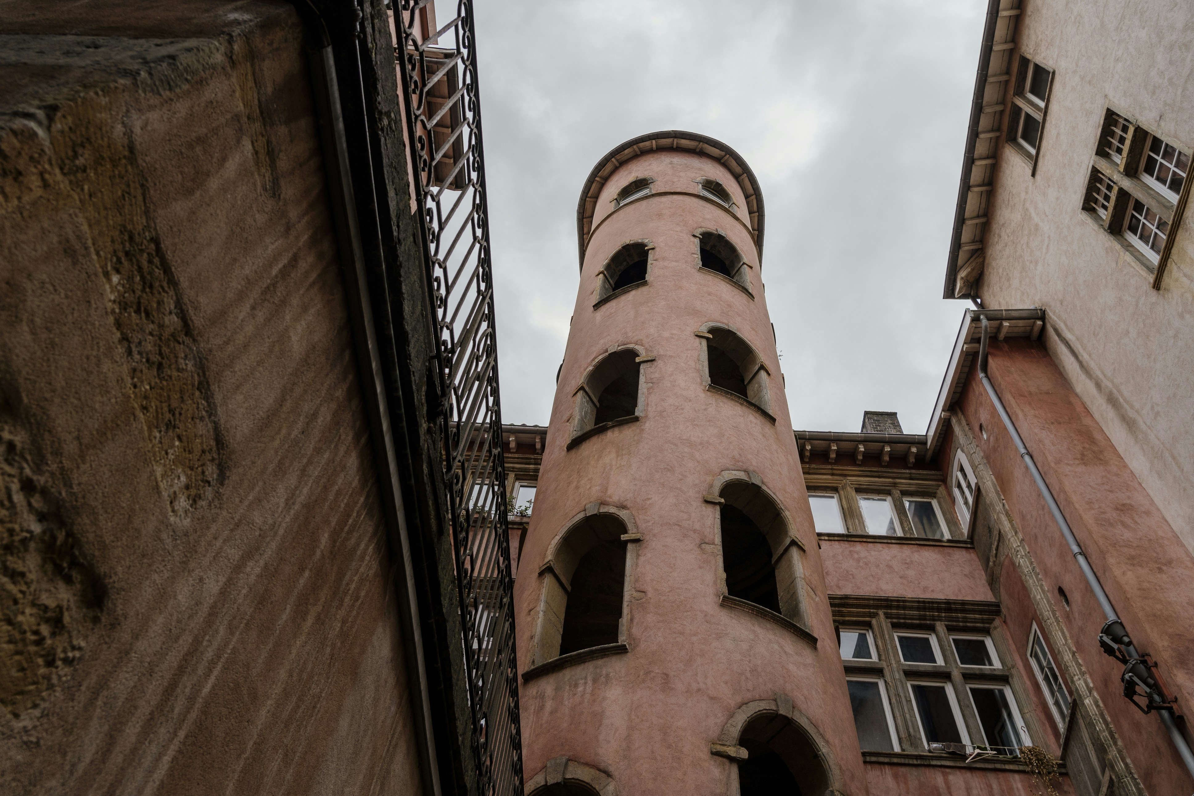 looking up at a tall brick building with windows