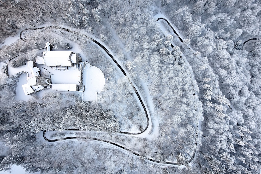 an aerial view of a snow covered country house