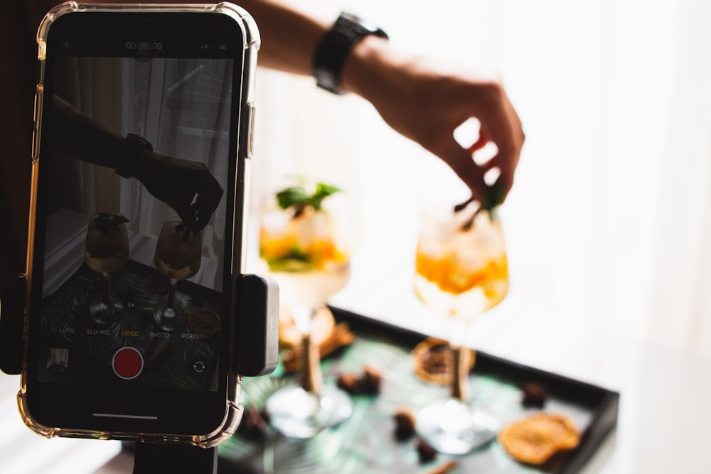 a person taking a picture of food on a table