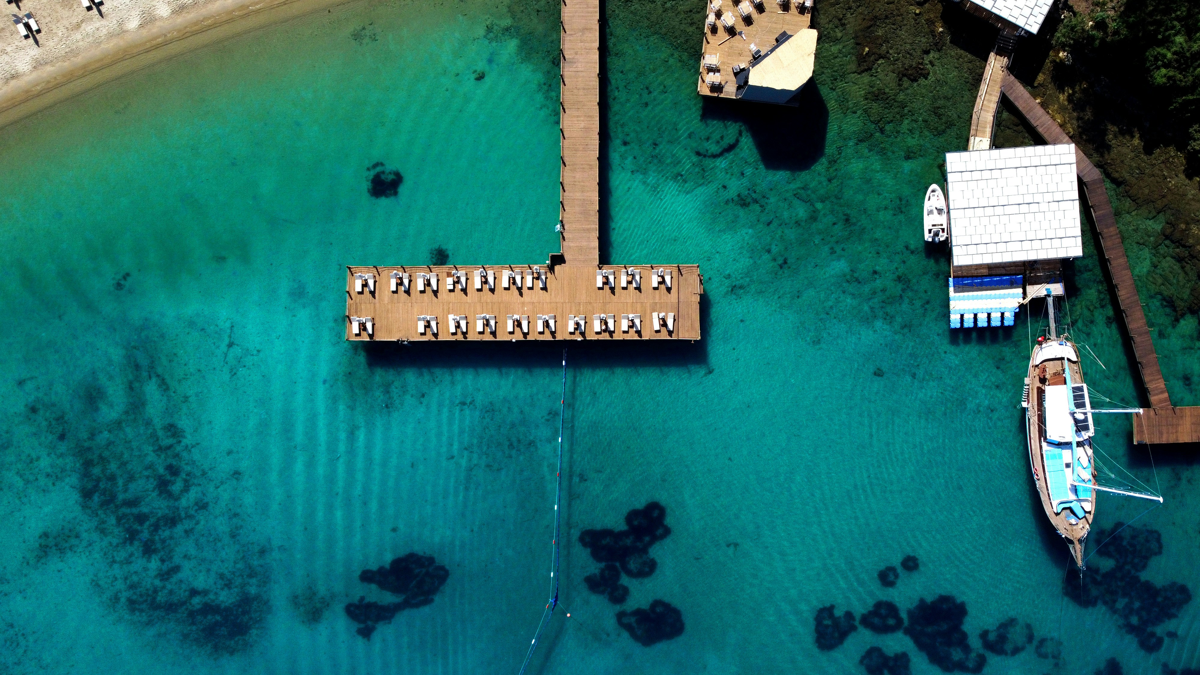 an aerial view of a dock and boats in the water