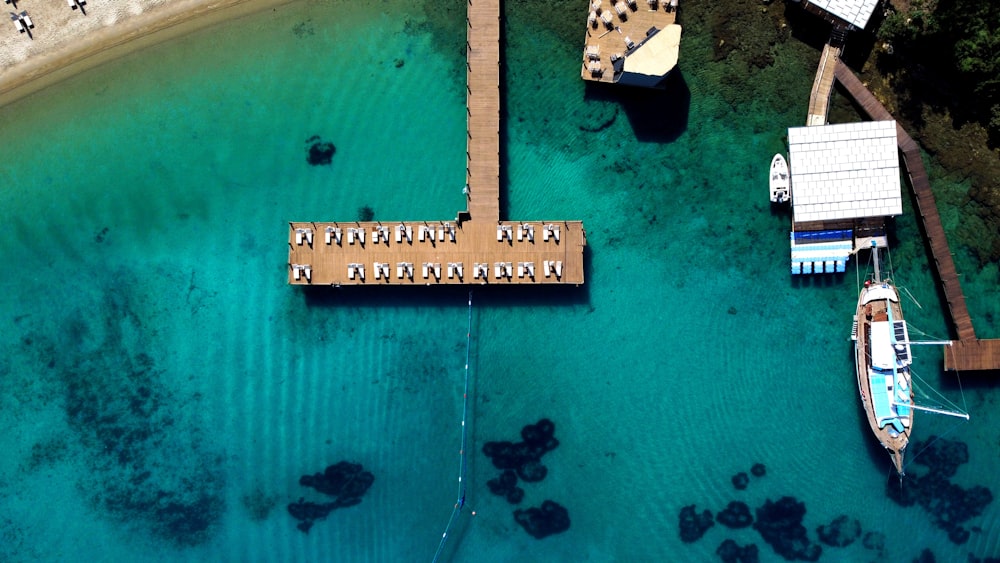 an aerial view of a dock and boats in the water