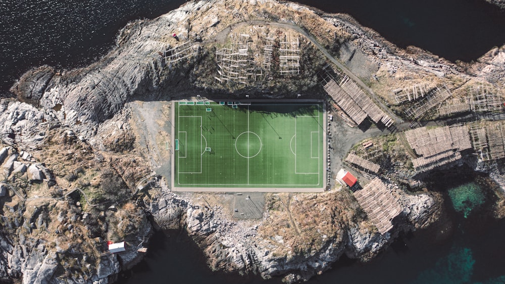an aerial view of a soccer field in a rocky area