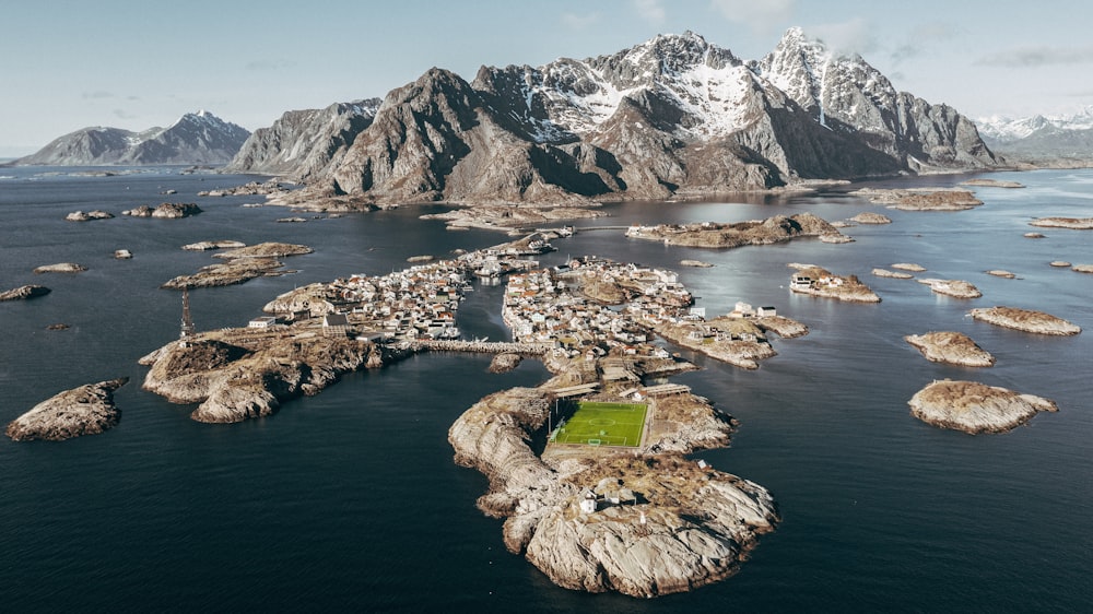 an aerial view of a small village in the middle of a body of water