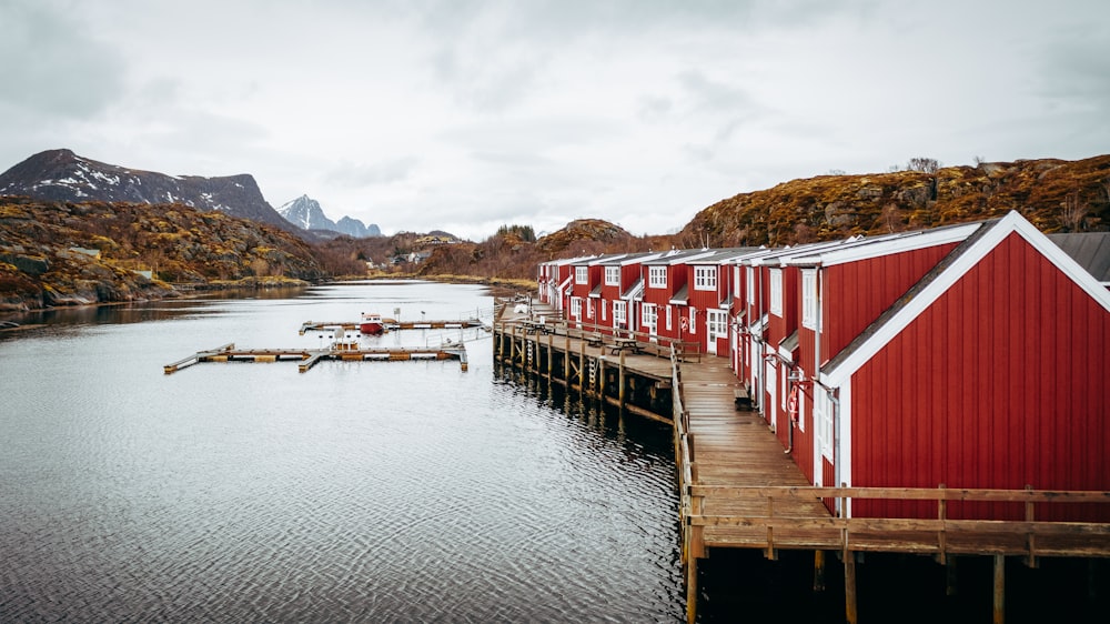 a dock with a row of red houses on it