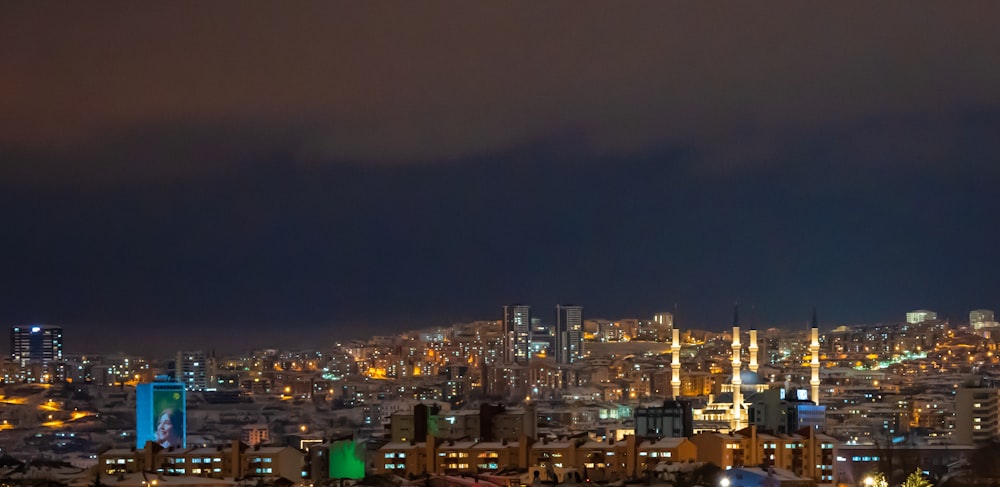 a view of a city at night from a hill