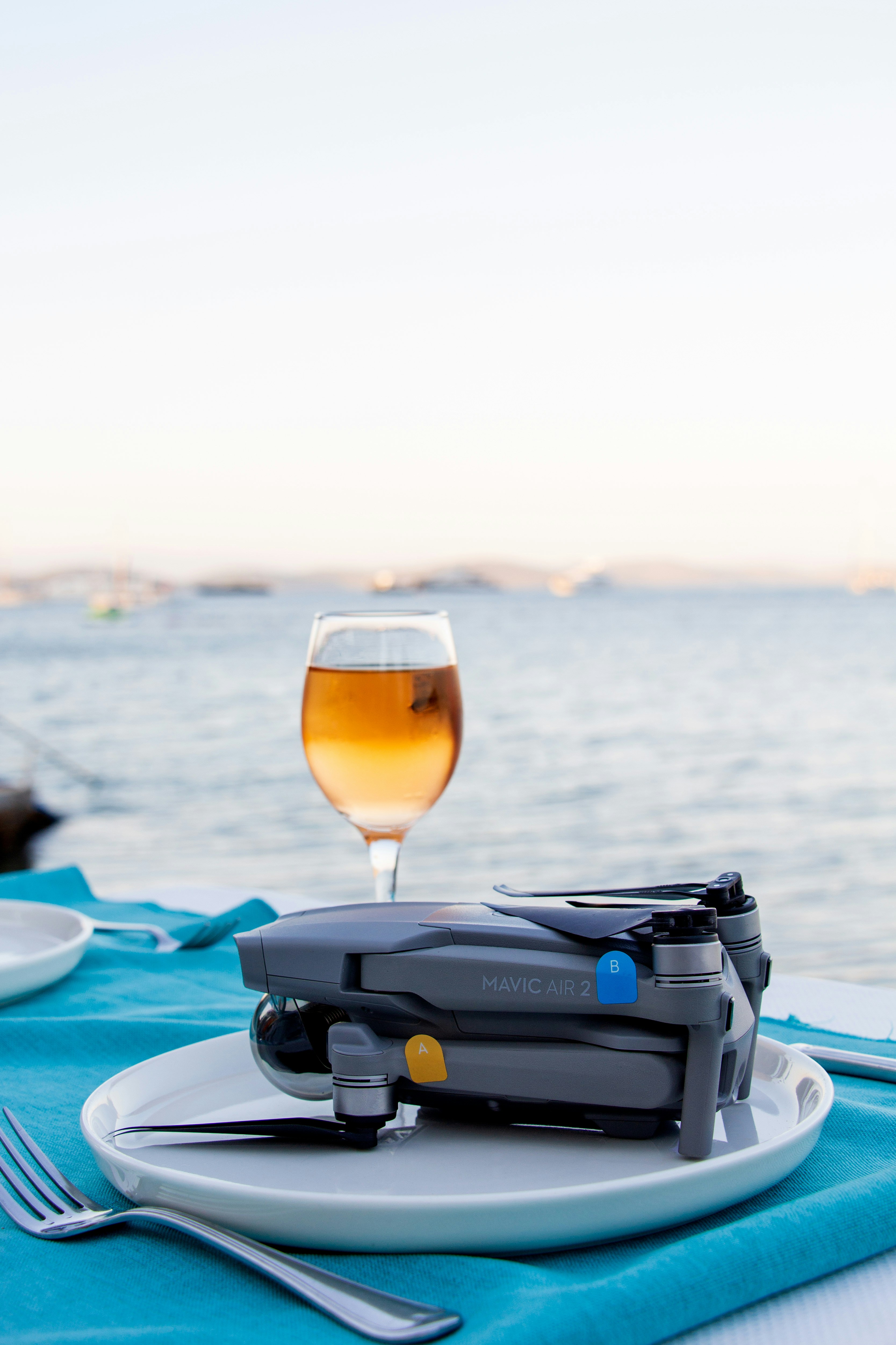 a glass of wine sitting on top of a white plate