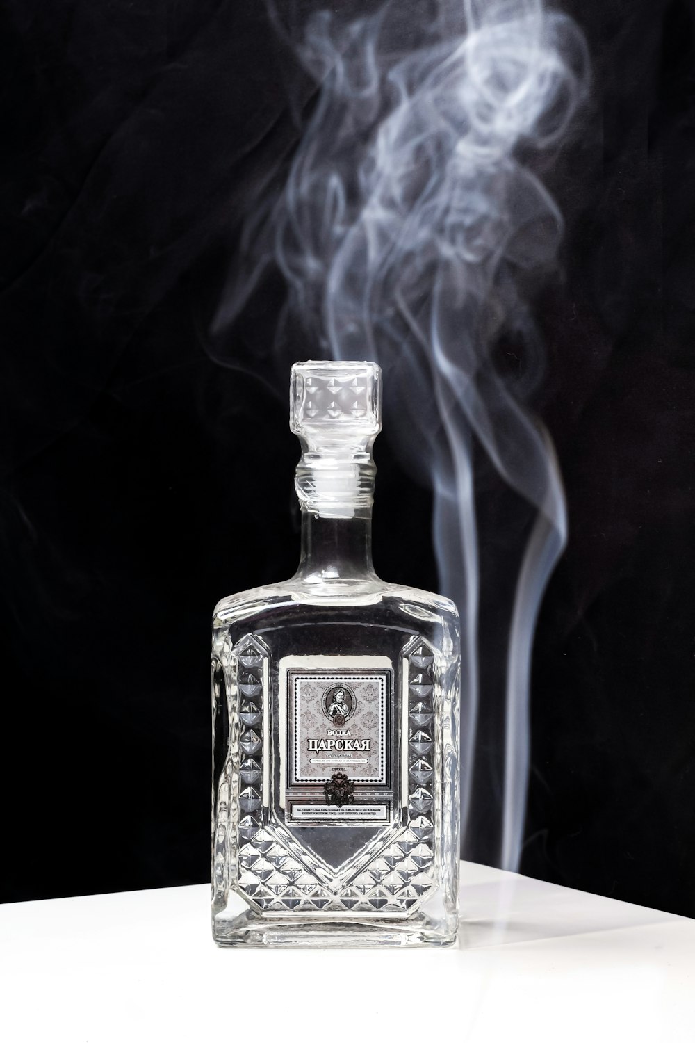 a bottle of liquor with smoke coming out of it