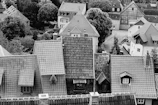 a black and white photo of rooftops and houses