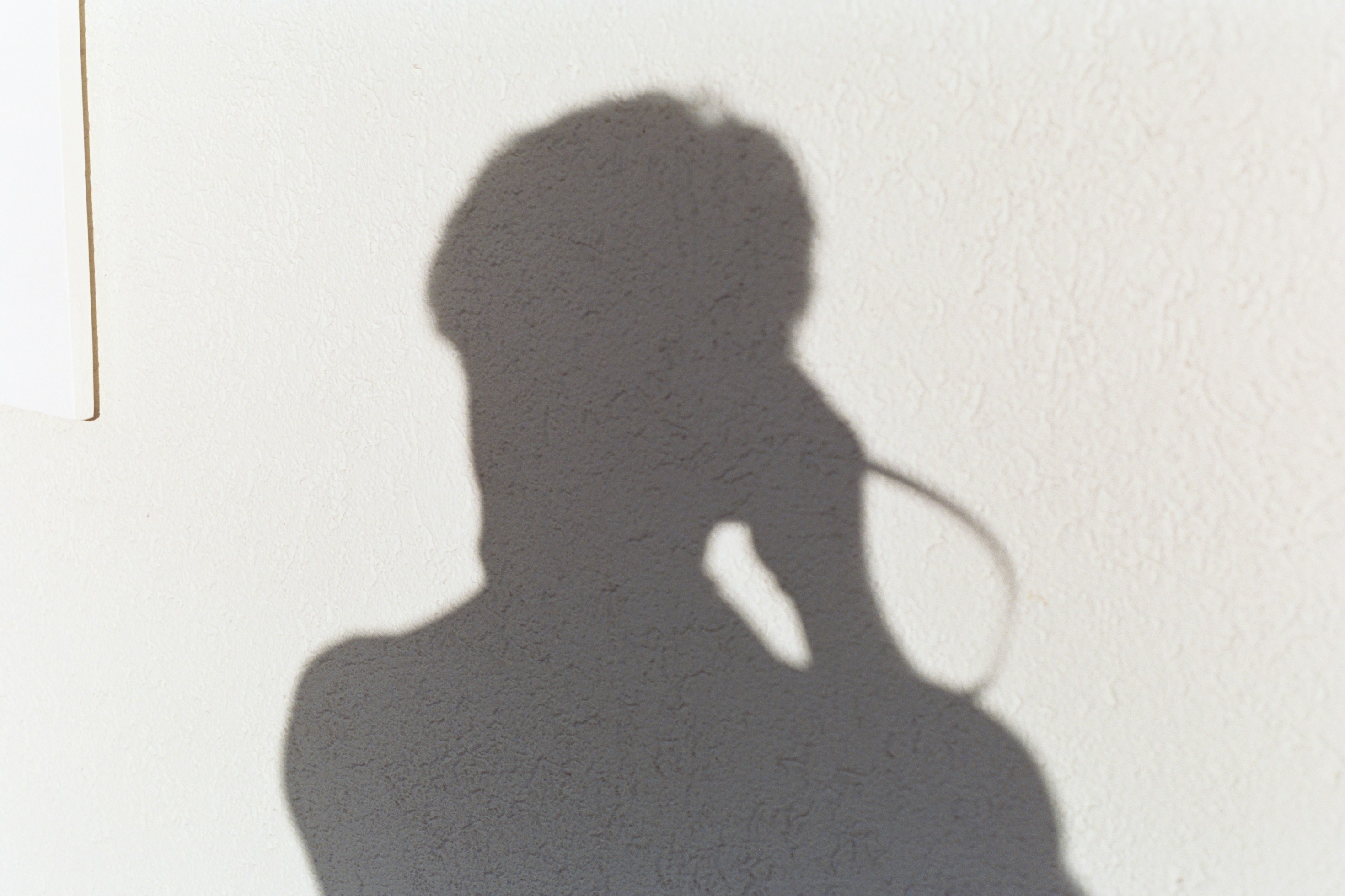 a shadow of a woman on a wall